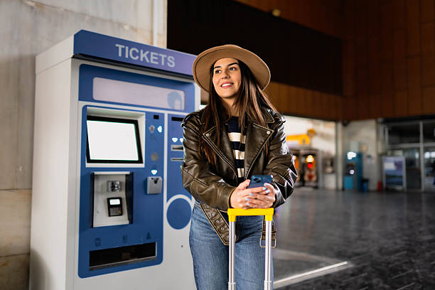 A woman buys a train ticket