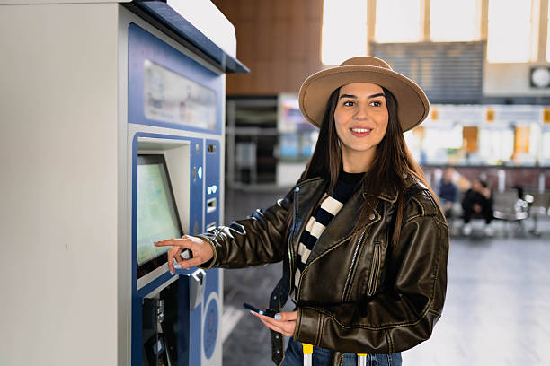 istock A woman buys a train ticket at a ticket machine. 2210469426