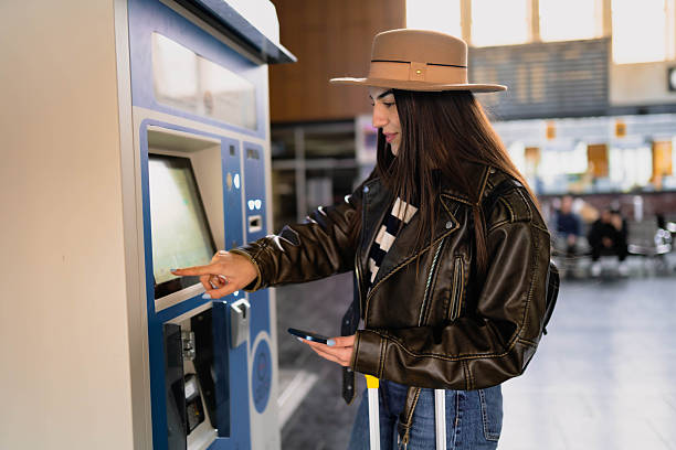 istock A woman buys a train ticket at a ticket machine. 2210469576