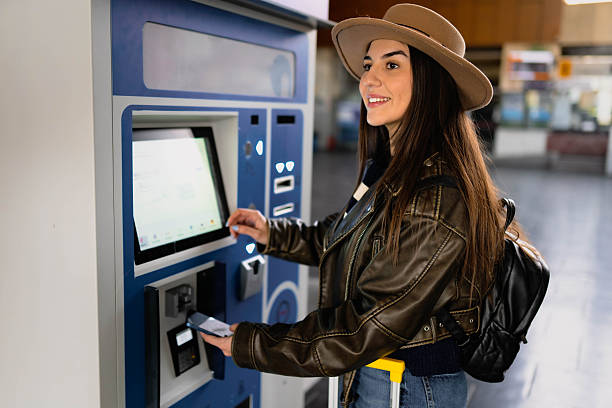 istock A woman buys a train ticket at a ticket machine. 2210469681