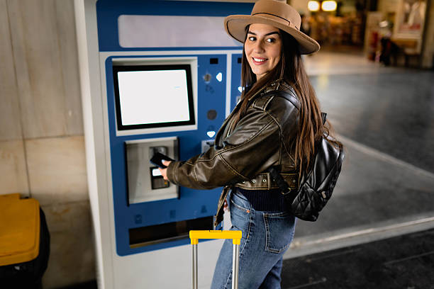 istock A woman buys a train ticket at a ticket machine. 2210469801