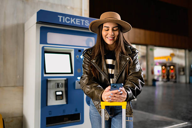 istock Woman using phone at train station 2210469805