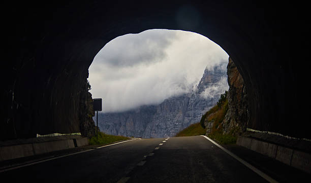 istock Mountain Road Tunnel Leading to Scenic Cloudy Landscape View 2210470141