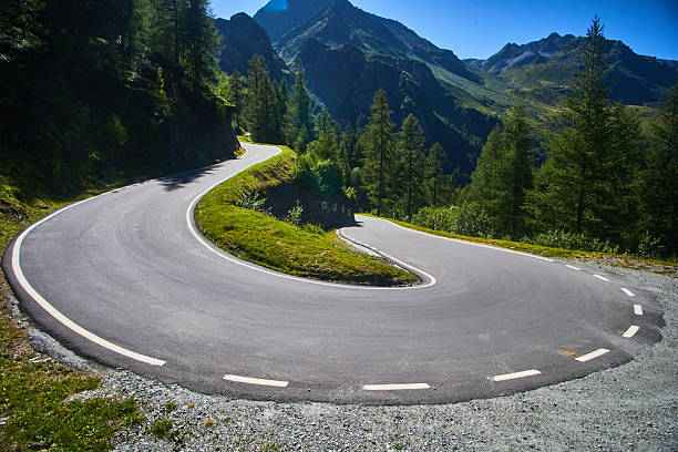 istock Scenic Mountain Road with Sharp Bend Through Alpine Landscape 2210472081