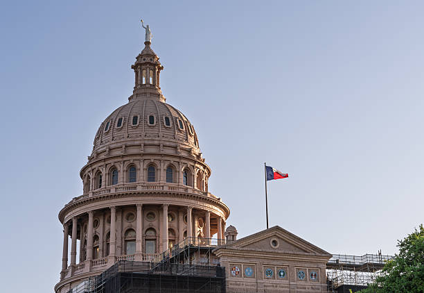 istock Texas State Capitol dome and flag with scaffolding from renovation work 2210473746