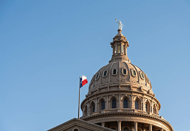 istock Texas State Capitol dome and flag as sun is setting 2210473771