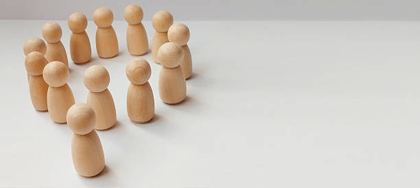 istock Team building activity office space wooden figures neutral colors wide angle collaboration and communication 2210473818