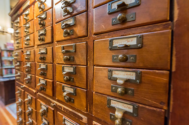 Providence, Rhode Island, USA - March 29, 2025: Antique wooden drawers containing the alphabetical card catalog, with information on where to find the books at The Providence Athenaeum library in Providence, Rhode Island.