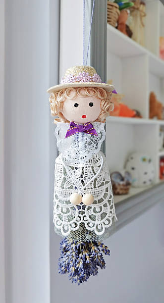 istock Whimsical doll suspended with lavender bunch channels romantic aura, romantic vibe 2210476661