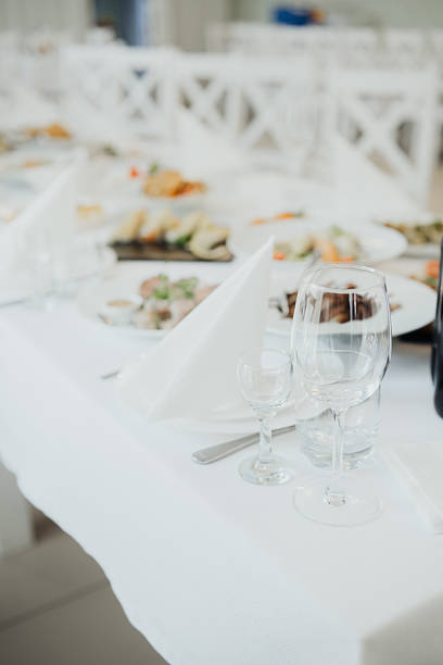 Table adorned with fine dishes and glassware, ready for a formal gathering.