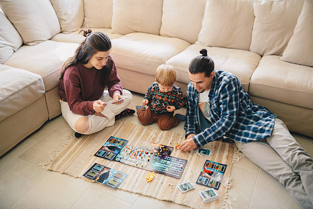 istock Young family showing their boy a board game. 2210477253
