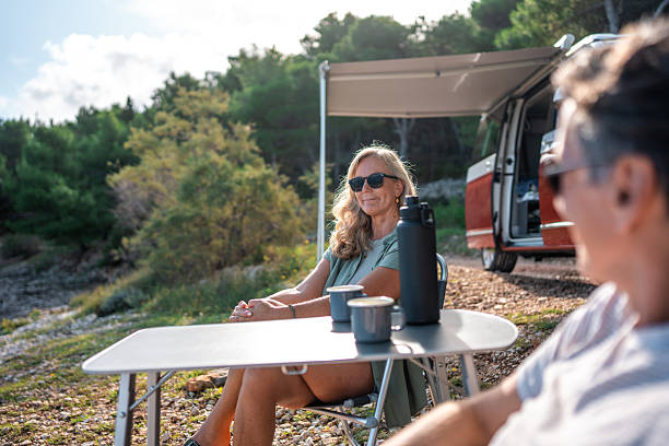istock Carefree Retirees Share Peaceful Coffee Moment at Coastal Camping Site 2210477627
