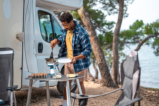 istock Independent Camper Making Breakfast At Scenic Oceanside Motorhome Location 2210477636