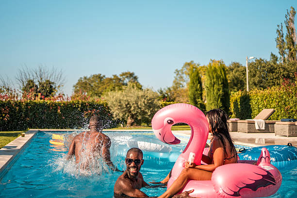 istock Diverse Friends Enjoy Cannonball Splash at Luxury Villa 2210483548