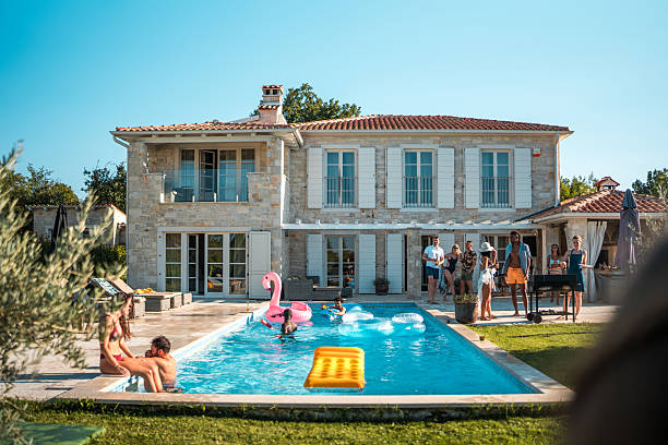 istock Friends Swimming at a Villa Pool Party 2210483570