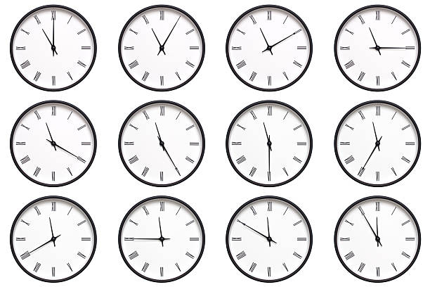 istock A set of 12 wall clocks with black frames and Roman numerals, each displaying a different time from 11:00 to 11:55 or 23:00 to 23:55. ideal for timekeeping, schedule management, and daily routines. 2210485841