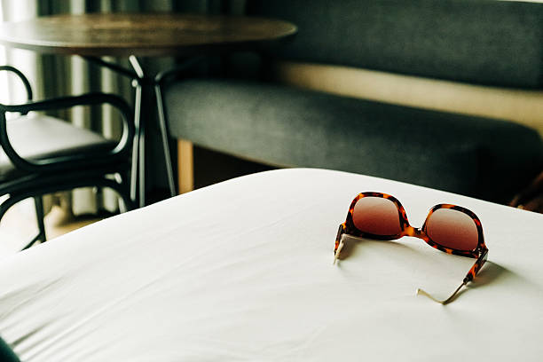 istock Sunglasses resting on a bed in a cozy indoor space 2210487742
