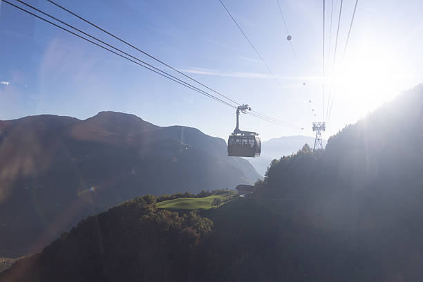 istock Cable car gliding above a sunlit mountain valley 2210488574