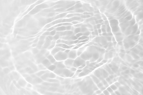istock Blue water with ripples on the surface. Defocus blurred transparent blue colored clear calm water surface texture with splashes and bubbles. Water waves with shining pattern texture background. 2210489404
