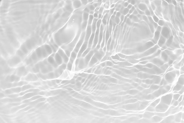 istock Blue water with ripples on the surface. Defocus blurred transparent blue colored clear calm water surface texture with splashes and bubbles. Water waves with shining pattern texture background. 2210489406