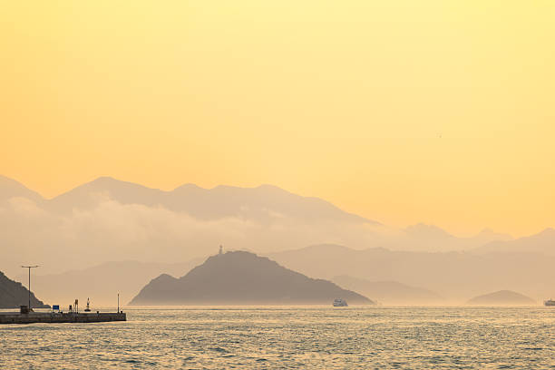 Seascape from Hong Kong Island with cloudy sunset sky.