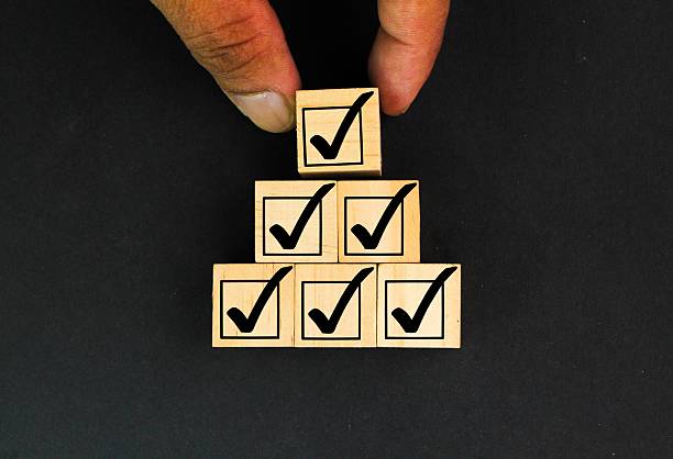 istock Businessman stacking correct or right sign symbol which print screen on wooden block cube for document and project approve concept. Elections and Voting, Vote, to do list, checklist, Task list, Survey 2210496660