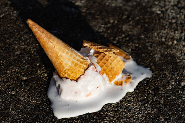 istock ice cream cone crashing on the floor dripping with melted ice cream 2210496692