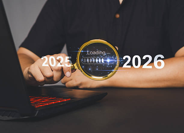 istock Hand holding magnifying glass showing 2025 Loading 2026. 2210497691
