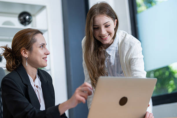 istock Two women engaged in a collaborative work session at a modern office during the day 2210498152