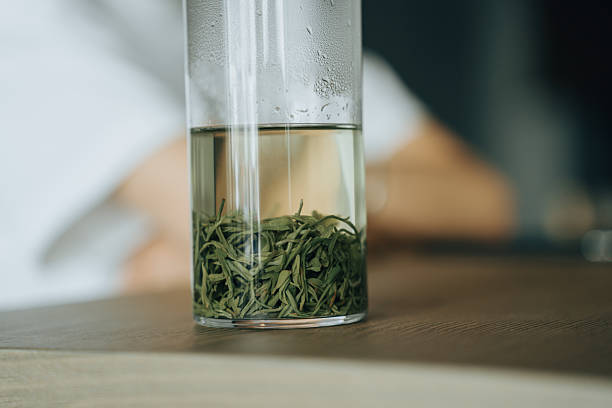 A cup of green tea placed on the table, close-up shot