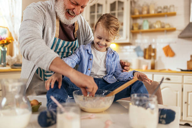 istock Grandpa helping grandson cook pancakes for breakfast 2210500011
