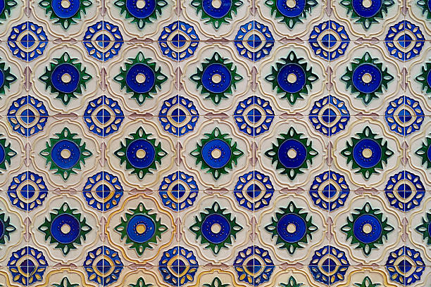 Full frame of a repeating floral tile pattern with green, blue, and yellow decorative motifs, commonly found on heritage shophouses in Penang.