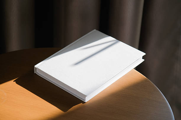 istock blank book mockup on wooden coffee table , shadow overlay 2210506590