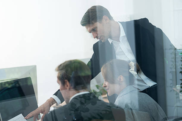 istock Business team discussing project details in modern office environment during daytime meeting 2210506592