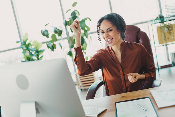 istock Young professional celebrating success in a modern office environment with natural light and stylish interior design showcasing achievement 2210508380