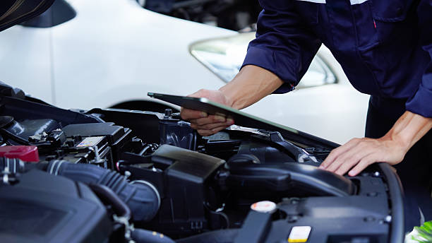 istock Auto mechanic hands using wrench to repair auto engine. Car maintenance, service at garage. Technician inspects vehicle for problems. Auto repair, fixing, check, services, insurance, checkup concept. 2210508856