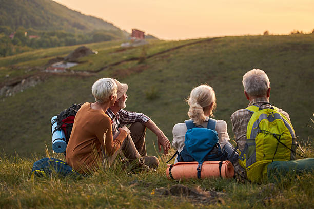 istock Group of seniors resting on a hill from hiking in springtime. 2210512327