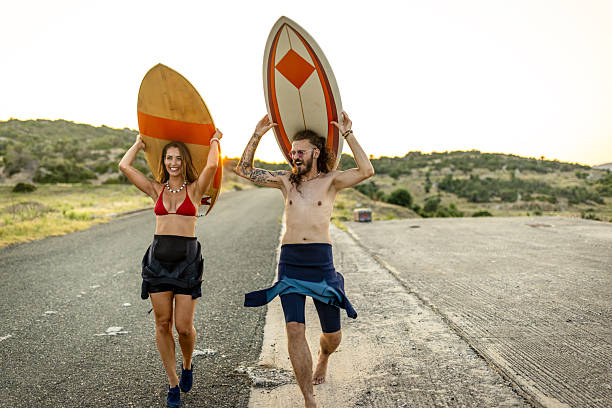 istock A couple with surf boards going surfing on the beach 2210512420