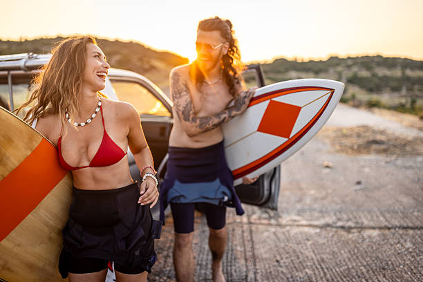istock A couple with surf boards going surfing on the beach 2210513119