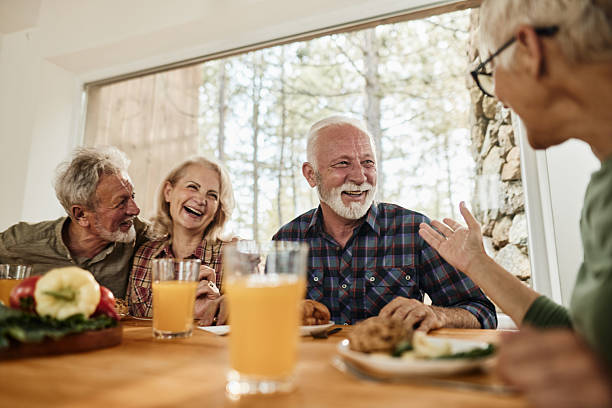 istock Cheerful senior friends talking during breakfast at home. 2210513511