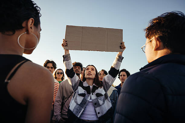 istock Group of passionate protestors holding a blank sign during a demonstration 2210517254