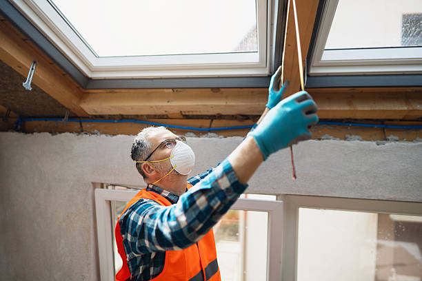 istock Worker measuring dimensions for attic window installation in renovation project 2210517301