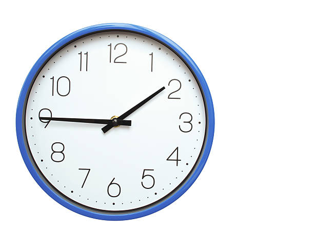 Wall clock with blue frame showing 1.45 01.45 or 13.45 O clock  on white background, suitable for time related articles, education, or punctuality concepts