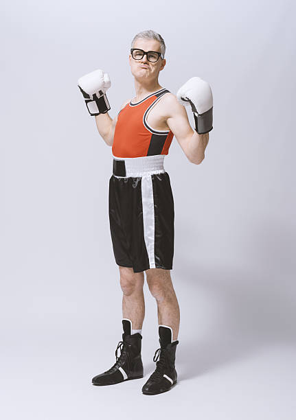 istock Funny skinny boxer showing off his muscles 2210517603