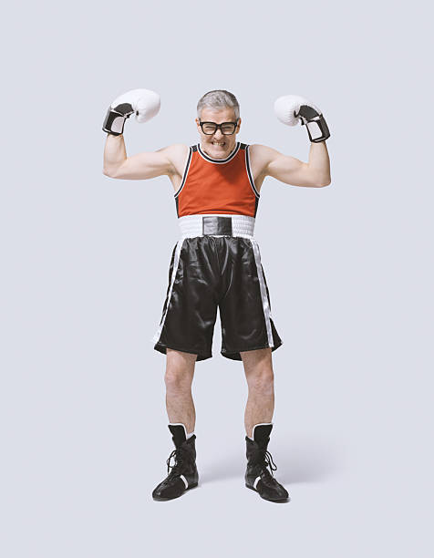 istock Funny skinny boxer showing off his muscles 2210517794