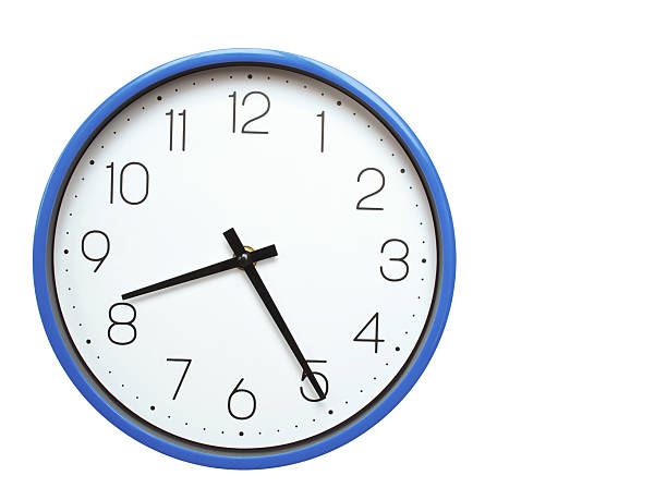 istock Wall clock with blue frame showing 8.25 08.25 or 20.25 O clock  on white background, suitable for time related articles, education, or punctuality concepts 2210517886