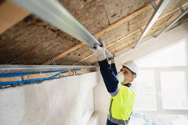 istock Worker Installing Installing Ceiling Aluminum Profile and Insulation in an Attic with Safety Gear and Tools 2210518044