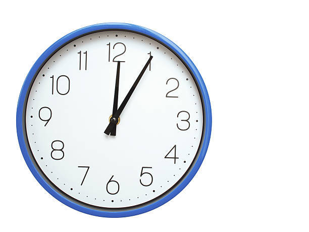 Wall clock with blue frame showing 12.05 00.05 or 12.05 O clock  on white background, suitable for time related articles, education, or punctuality concepts