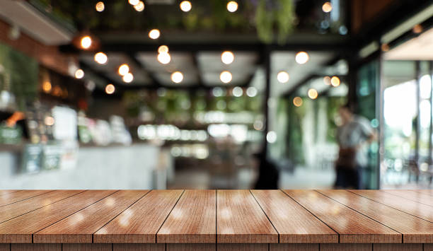 istock Empty wooden table top with lights bokeh on blur restaurant background. 2210518164