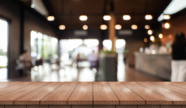 istock Empty wooden table top with lights bokeh on blur restaurant background. 2210518184